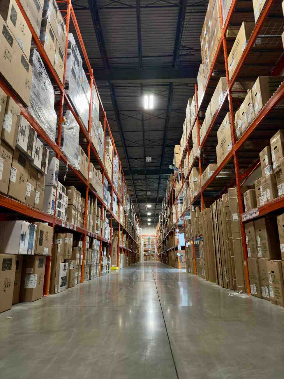 High-density retail warehouse aisles with organized packages for ecommerce fulfillment.